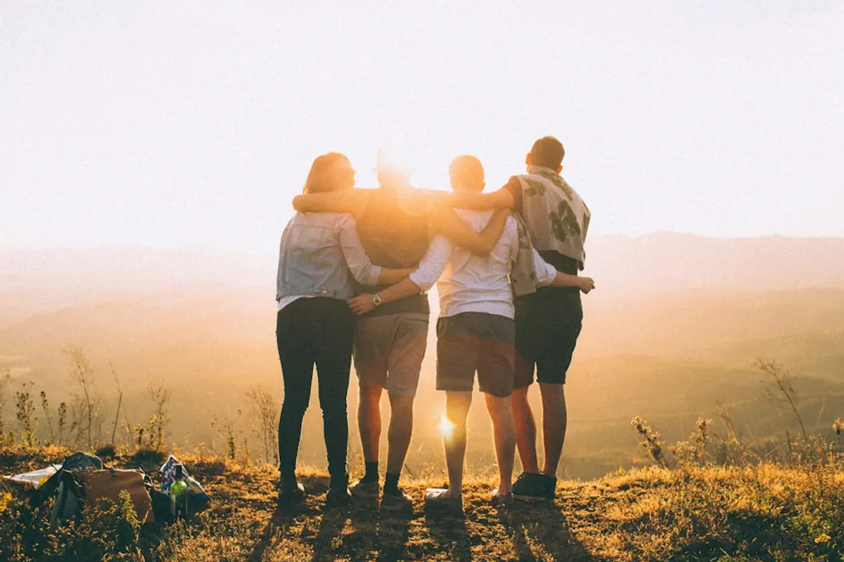 Group of friends laughing together, demonstrating social proof in dating photography
